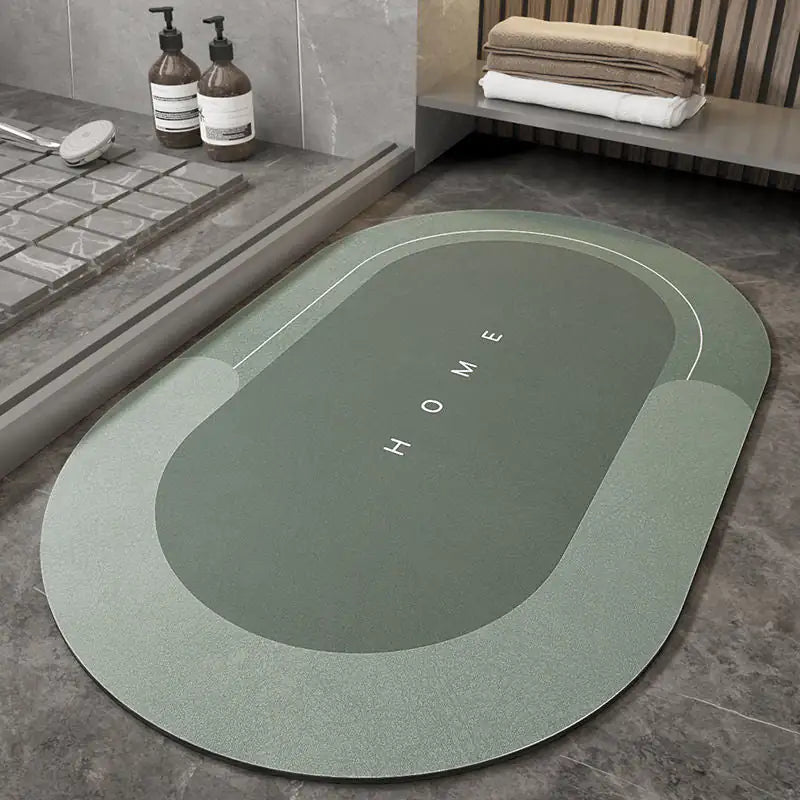 oval gray Napa Skin Super Absorbent Bath Mat on floor near a shower