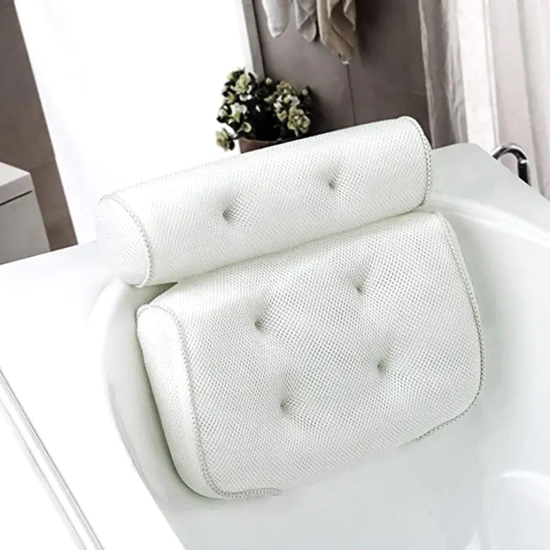 bath pillow set up in bathtub with a plant and hanging towel