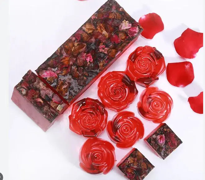 six soap roses next to the bar they were carved from
