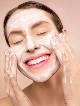 a woman using a facial cream