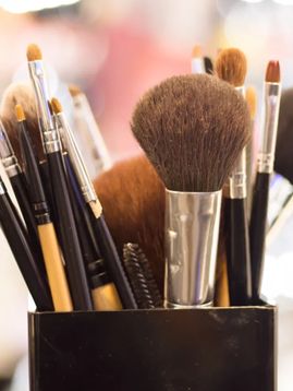 a container filled with makeup brushes