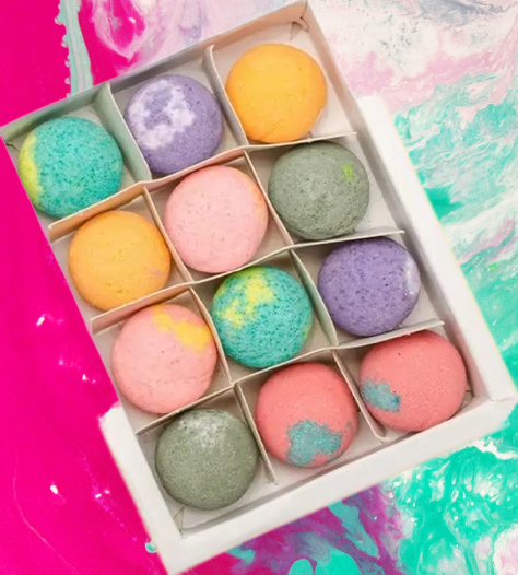 a box of twelve multi-colored bath bombs