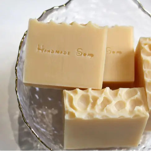  four bars of Milk Honey Natural Handmade Soap in a glass bowl