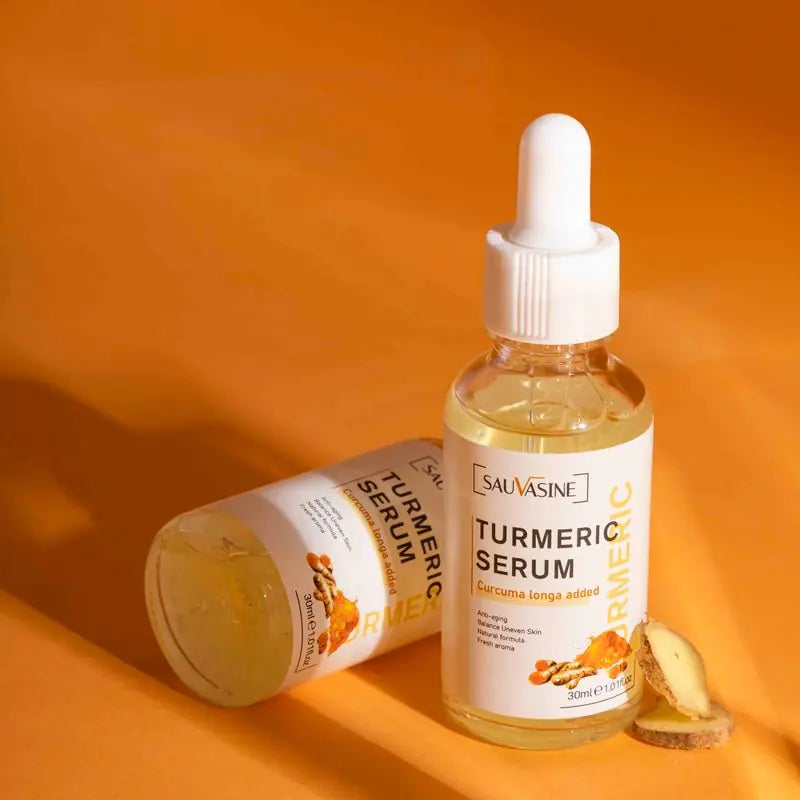 bottles of serum with a slice of fresh tumeric