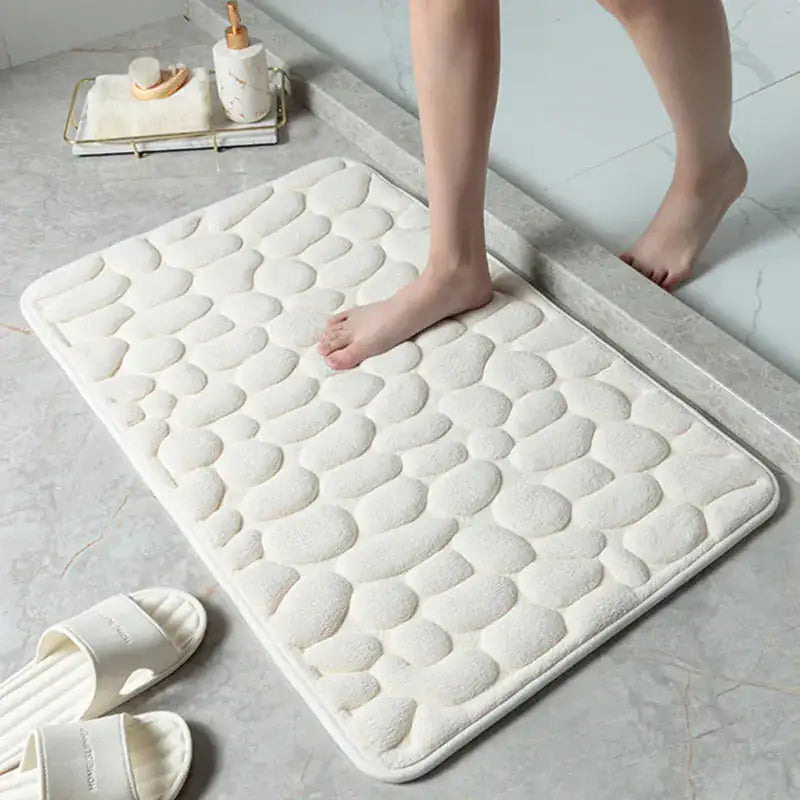 A woman stepping out of the shower onto the white Memory Foam Bath Mat