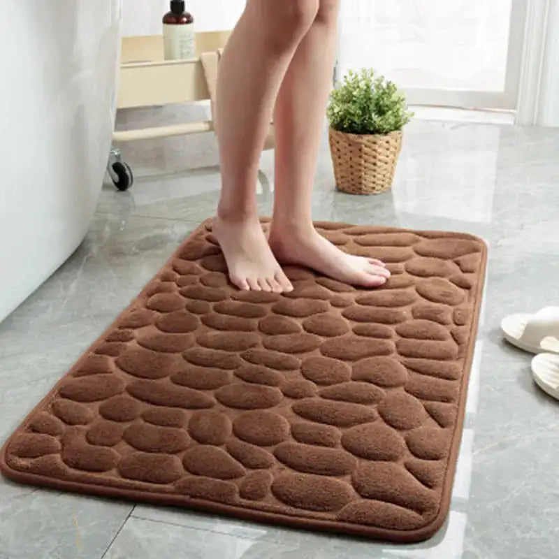 A woman stepping out of the bathtub onto a coffee brown colored Memory Foam Bath Mat.