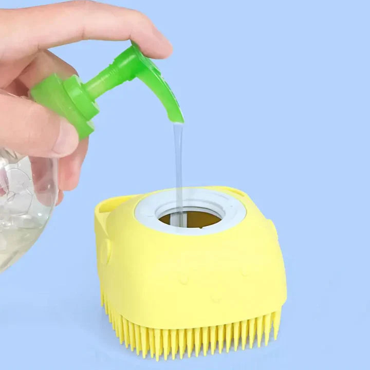 Silicone Dog Bath Brush being filled with soap in a hole at the top of brush