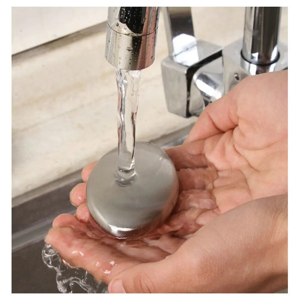 kitchen sink water running over stainless-steel soap in someone's hands